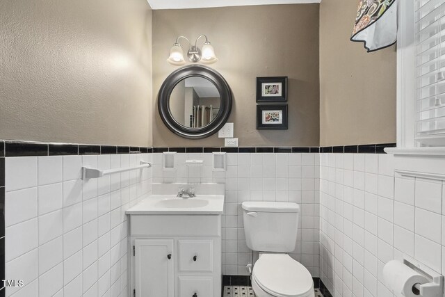 418 S W St, Cary, NC 27511 - half bath with tile walls, toilet, a wainscoted wall, and vanity