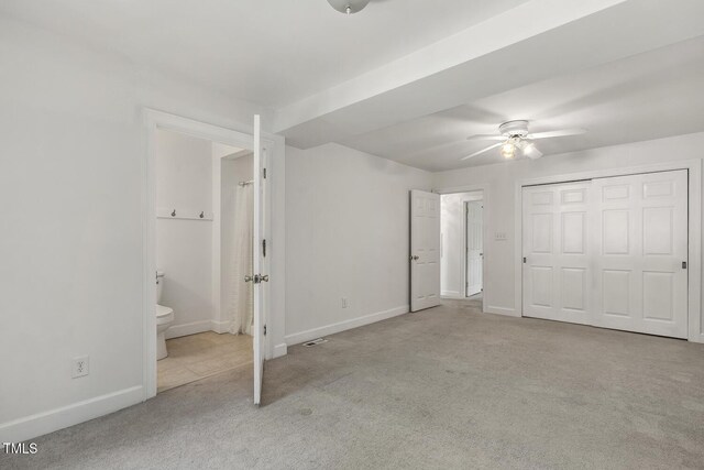 418 S W St, Cary, NC 27511 - unfurnished bedroom with carpet floors, baseboards, connected bathroom, a closet, and ceiling fan