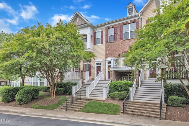 9211 Calabria Dr Unit 104, Raleigh, NC 27617 - townhome / multi-family property with stairs and brick siding