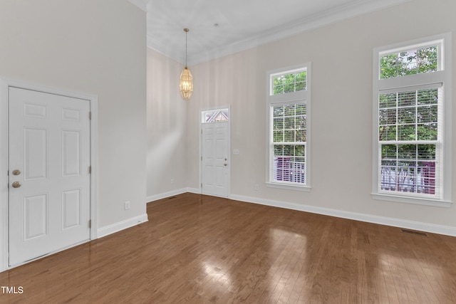 9211 Calabria Dr Unit 104, Raleigh, NC 27617 - foyer entrance with wood finished floors, baseboards, and ornamental molding