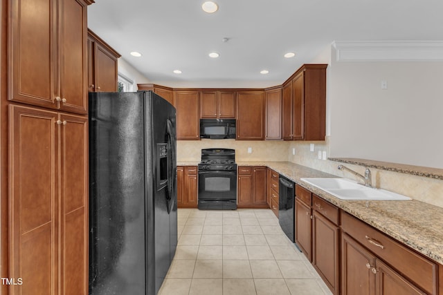 9211 Calabria Dr Unit 104, Raleigh, NC 27617 - kitchen with black appliances, a sink, tasteful backsplash, light tile patterned floors, and recessed lighting