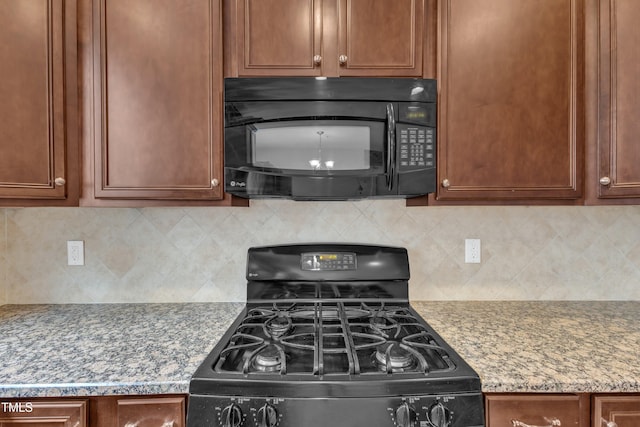 9211 Calabria Dr Unit 104, Raleigh, NC 27617 - kitchen with black appliances and decorative backsplash