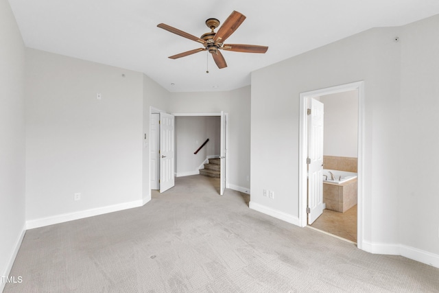 9211 Calabria Dr Unit 104, Raleigh, NC 27617 - unfurnished bedroom featuring carpet floors, baseboards, connected bathroom, and ceiling fan