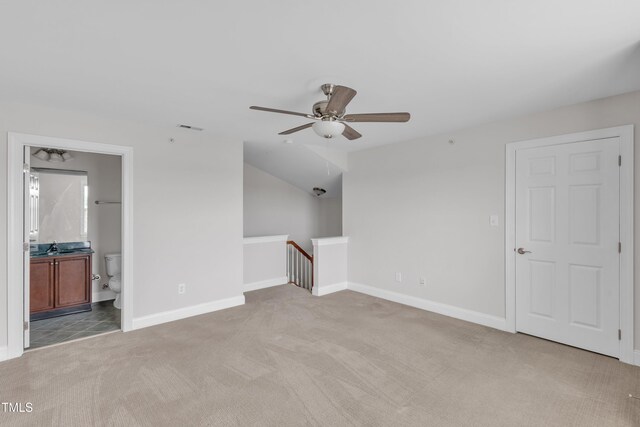 9211 Calabria Dr Unit 104, Raleigh, NC 27617 - unfurnished living room with light colored carpet, a ceiling fan, baseboards, and a sink