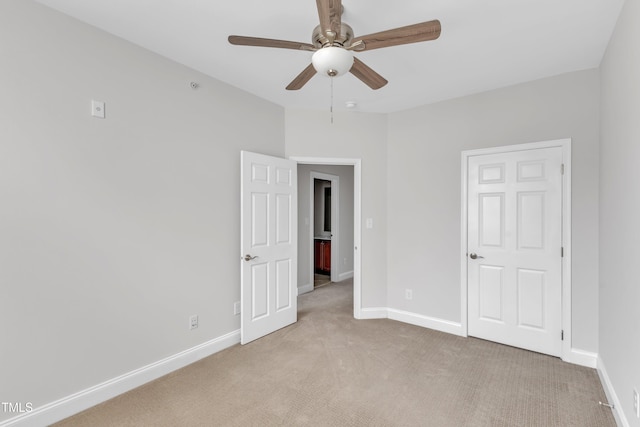 9211 Calabria Dr Unit 104, Raleigh, NC 27617 - unfurnished bedroom featuring light colored carpet, baseboards, and a ceiling fan