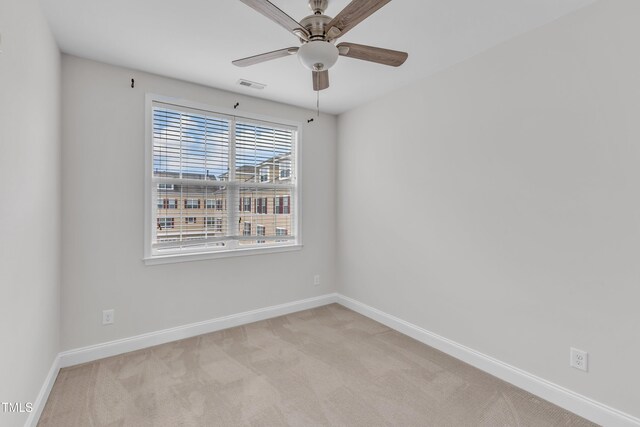 9211 Calabria Dr Unit 104, Raleigh, NC 27617 - spare room featuring a ceiling fan, light carpet, and baseboards
