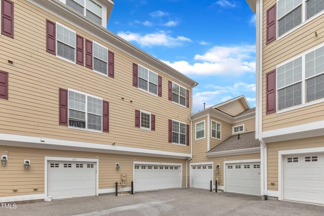 9211 Calabria Dr Unit 104, Raleigh, NC 27617 - exterior space with driveway and a garage