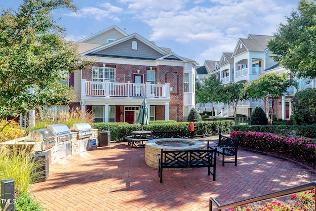 9211 Calabria Dr Unit 104, Raleigh, NC 27617 - view of patio with a balcony and an outdoor fire pit