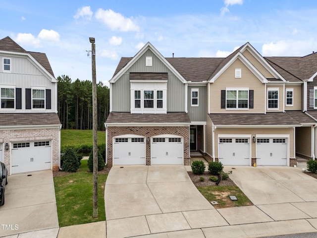 1151 Epiphany Rd, Morrisville, NC 27560 - view of front of property featuring brick siding, concrete driveway, an attached garage, and board and batten siding