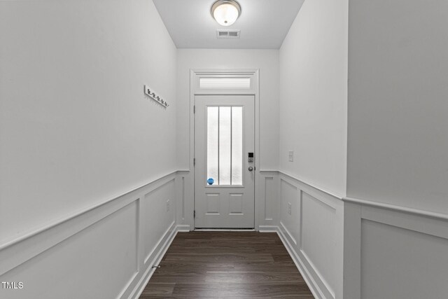 1151 Epiphany Rd, Morrisville, NC 27560 - doorway to outside featuring a decorative wall, wainscoting, and dark wood finished floors