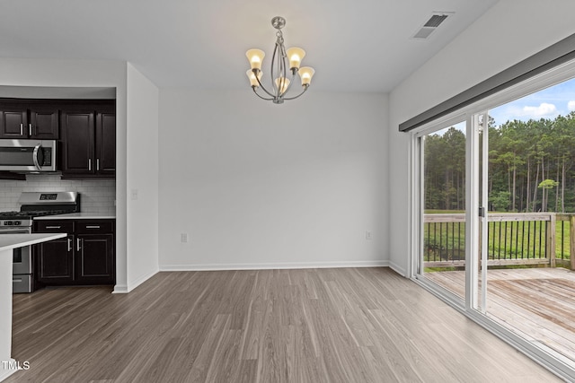 1151 Epiphany Rd, Morrisville, NC 27560 - unfurnished dining area featuring light wood-style flooring and a chandelier