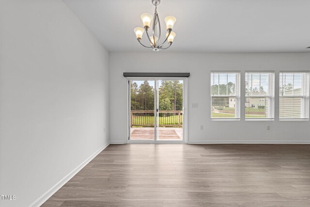 1151 Epiphany Rd, Morrisville, NC 27560 - spare room featuring a chandelier and wood finished floors