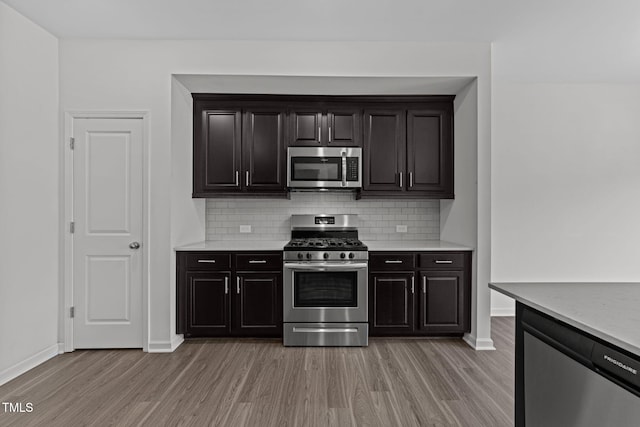1151 Epiphany Rd, Morrisville, NC 27560 - kitchen featuring stainless steel appliances, light wood-style flooring, decorative backsplash, and light countertops