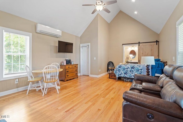 509 Spruce Meadows Ln, Willow Springs, NC 27592 - bedroom featuring a wall mounted air conditioner, light wood-style floors, high vaulted ceiling, baseboards, and a barn door