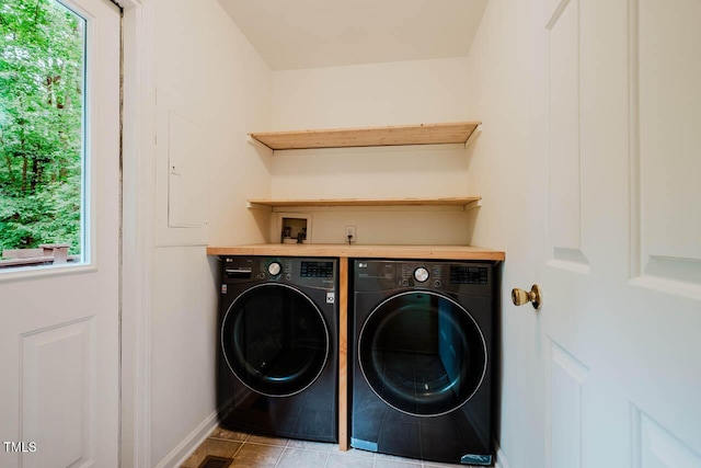 106 Redbud, Pittsboro, NC 27312 - washroom with washer and clothes dryer, plenty of natural light, baseboards, and tile patterned floors
