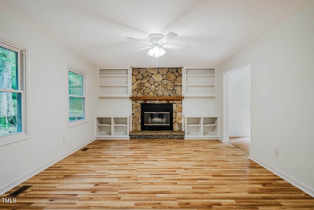 106 Redbud, Pittsboro, NC 27312 - unfurnished living room featuring built in shelves, a ceiling fan, wood finished floors, and baseboards