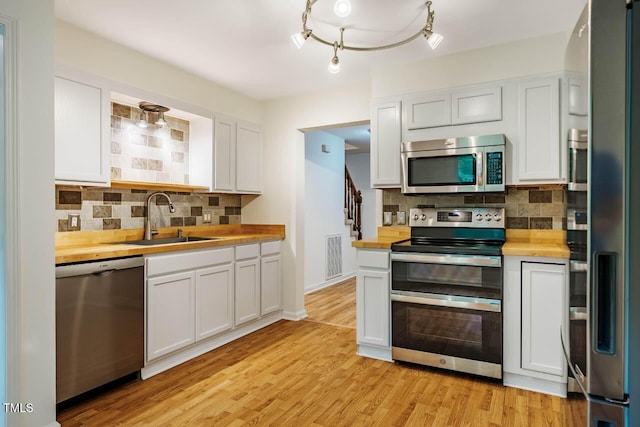 106 Redbud, Pittsboro, NC 27312 - kitchen featuring stainless steel appliances, wooden counters, a sink, and backsplash