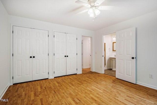 106 Redbud, Pittsboro, NC 27312 - unfurnished bedroom featuring multiple closets, light wood-style floors, baseboards, ensuite bath, and ceiling fan