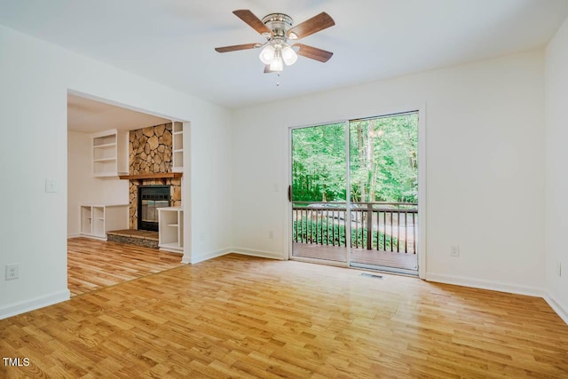 106 Redbud, Pittsboro, NC 27312 - unfurnished living room with wood finished floors, built in features, a ceiling fan, and baseboards