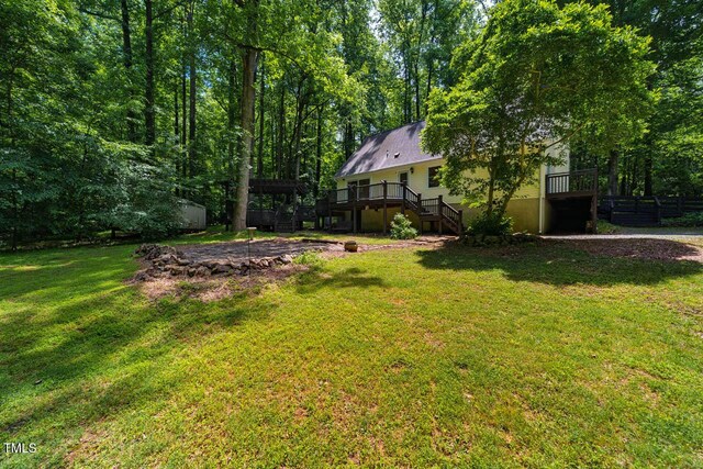 106 Redbud, Pittsboro, NC 27312 - view of grassy yard featuring stairway and a wooden deck
