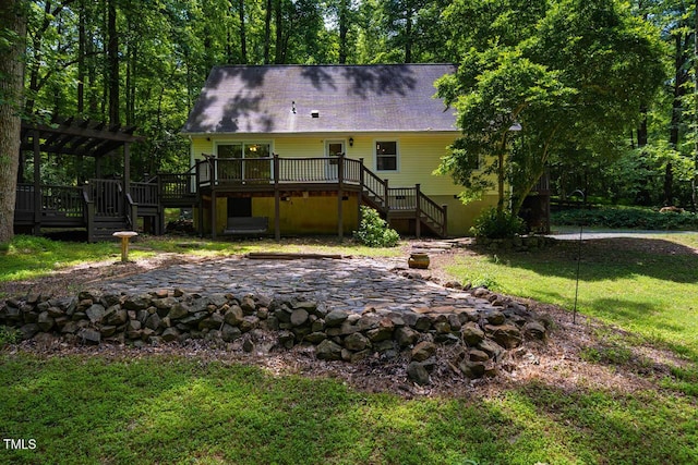 106 Redbud, Pittsboro, NC 27312 - back of property with stairway, a wooden deck, a patio, a lawn, and a pergola
