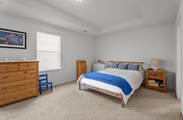 506 Oak Forest View Ln, Wake Forest, NC 27587 - carpeted bedroom featuring a tray ceiling and baseboards