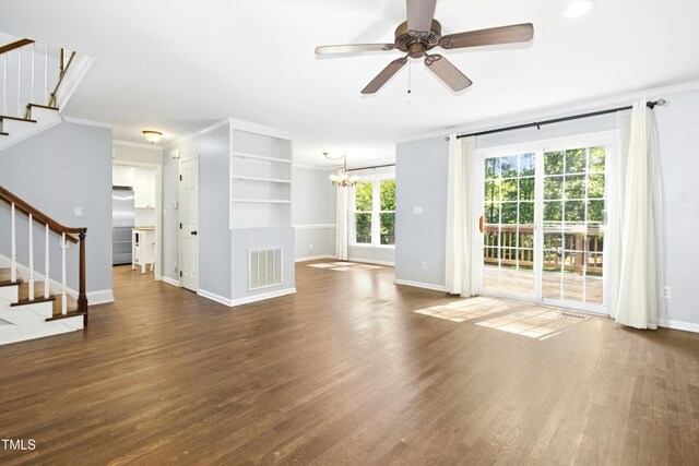 6912 Baywood Dr, Raleigh, NC 27613 - unfurnished living room with ornamental molding, stairs, baseboards, a chandelier, and a ceiling fan