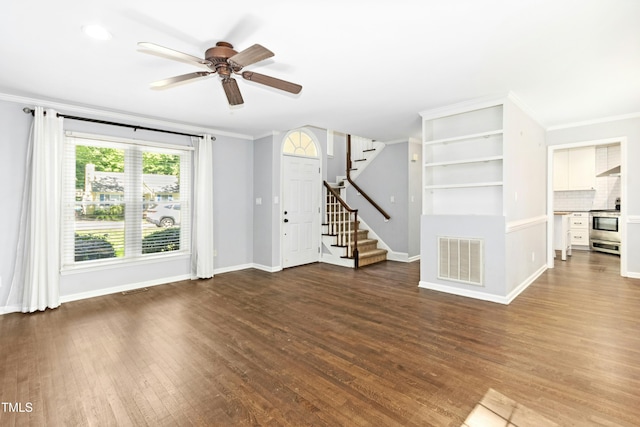 6912 Baywood Dr, Raleigh, NC 27613 - unfurnished living room featuring stairs, ornamental molding, a ceiling fan, wood finished floors, and baseboards