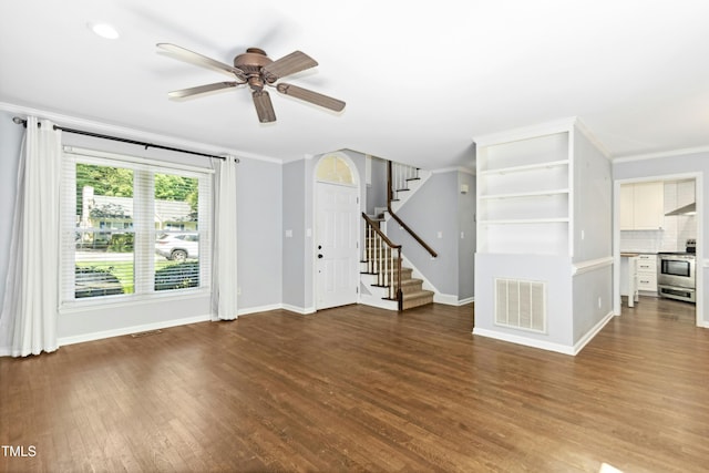 6912 Baywood Dr, Raleigh, NC 27613 - unfurnished living room featuring ceiling fan, crown molding, wood finished floors, baseboards, and stairs