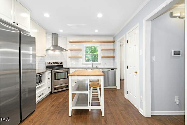 6912 Baywood Dr, Raleigh, NC 27613 - kitchen featuring butcher block countertops, wall chimney range hood, appliances with stainless steel finishes, open shelves, and tasteful backsplash
