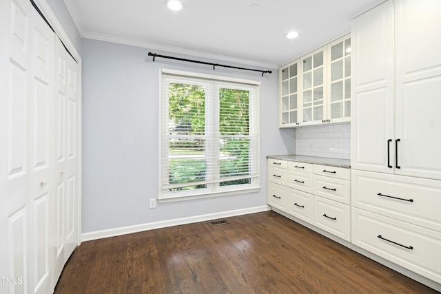 6912 Baywood Dr, Raleigh, NC 27613 - unfurnished dining area featuring ornamental molding, baseboards, dark wood-style flooring, and recessed lighting