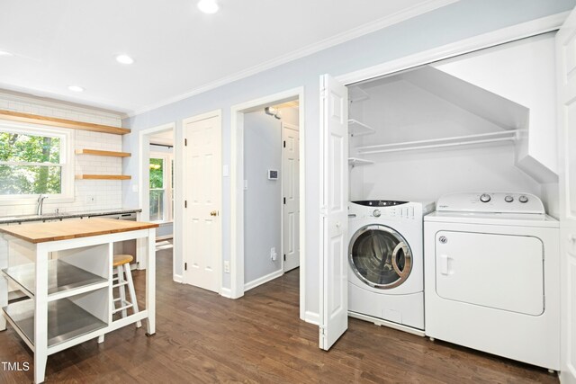 6912 Baywood Dr, Raleigh, NC 27613 - laundry area featuring washer and clothes dryer, ornamental molding, recessed lighting, dark wood finished floors, and baseboards