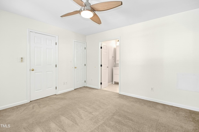 6912 Baywood Dr, Raleigh, NC 27613 - unfurnished bedroom featuring light colored carpet, baseboards, ensuite bathroom, and a ceiling fan
