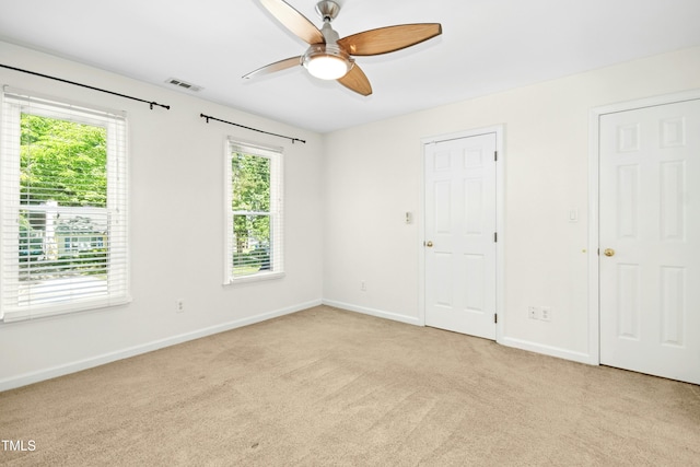 6912 Baywood Dr, Raleigh, NC 27613 - unfurnished bedroom featuring multiple windows and light carpet