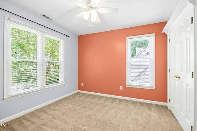 6912 Baywood Dr, Raleigh, NC 27613 - unfurnished bedroom with light carpet, multiple windows, and baseboards