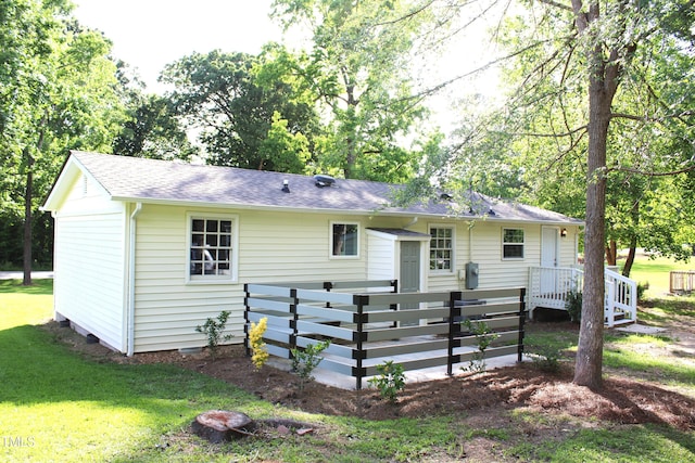 10180 Buffalo Rd, Clayton, NC 27527 - rear view of house featuring roof with shingles and a yard
