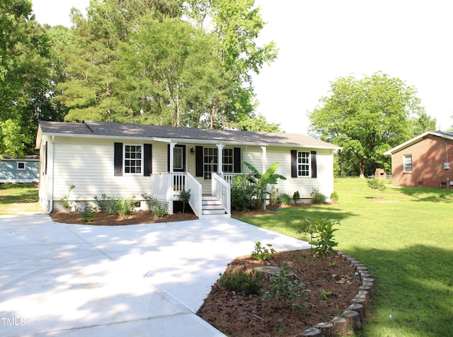 10180 Buffalo Rd, Clayton, NC 27527 - ranch-style home featuring covered porch, a front yard, and concrete driveway