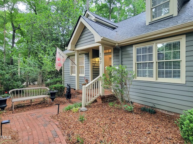 107 Long Shadow Ln, Cary, NC 27518 - property entrance featuring roof with shingles, a patio area, and crawl space