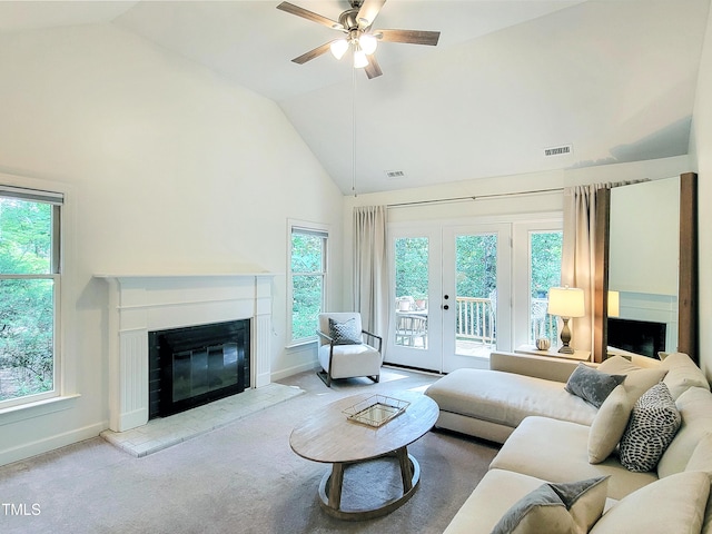 107 Long Shadow Ln, Cary, NC 27518 - carpeted living room featuring a glass covered fireplace, healthy amount of natural light, baseboards, and high vaulted ceiling