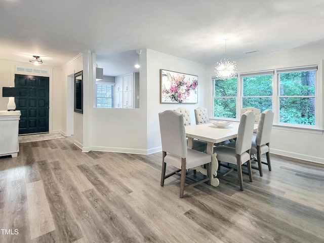 107 Long Shadow Ln, Cary, NC 27518 - dining area featuring crown molding, baseboards, a chandelier, and wood finished floors