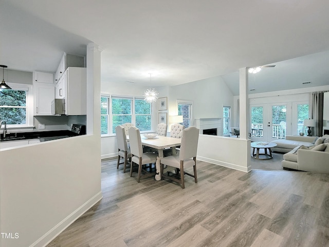 107 Long Shadow Ln, Cary, NC 27518 - dining area featuring light wood-style flooring, a fireplace, and baseboards