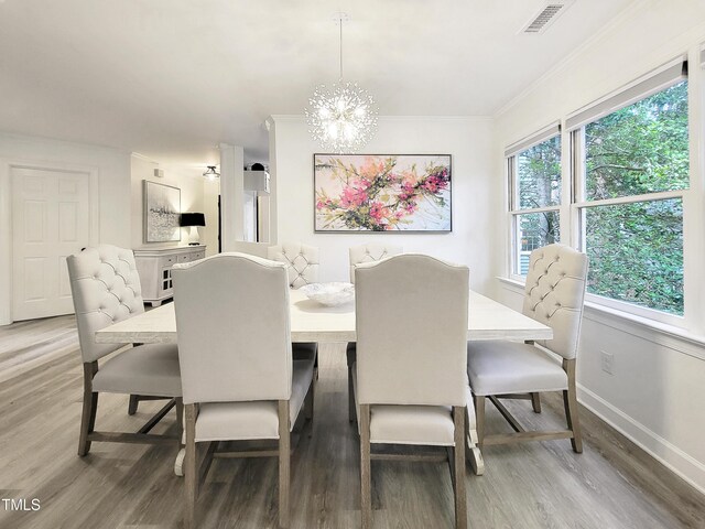 107 Long Shadow Ln, Cary, NC 27518 - dining space featuring wood finished floors, a chandelier, baseboards, and crown molding
