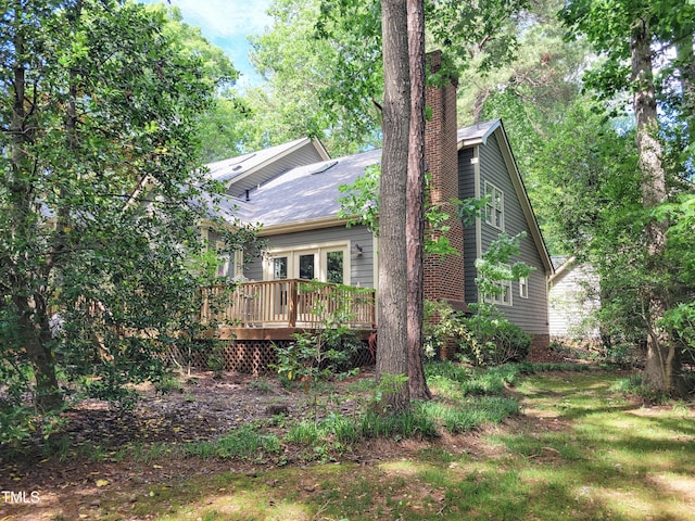 107 Long Shadow Ln, Cary, NC 27518 - view of property exterior with a wooden deck and a chimney