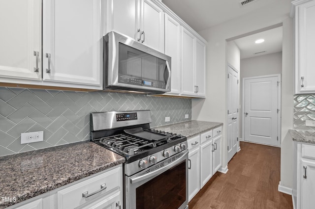 256 Rubrum Dr, Hillsborough, NC 27278 - kitchen featuring stainless steel appliances, dark wood-type flooring, white cabinetry, and dark stone counters
