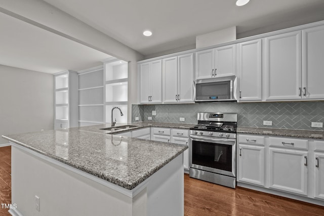 256 Rubrum Dr, Hillsborough, NC 27278 - kitchen with appliances with stainless steel finishes, a peninsula, white cabinetry, backsplash, and light stone countertops
