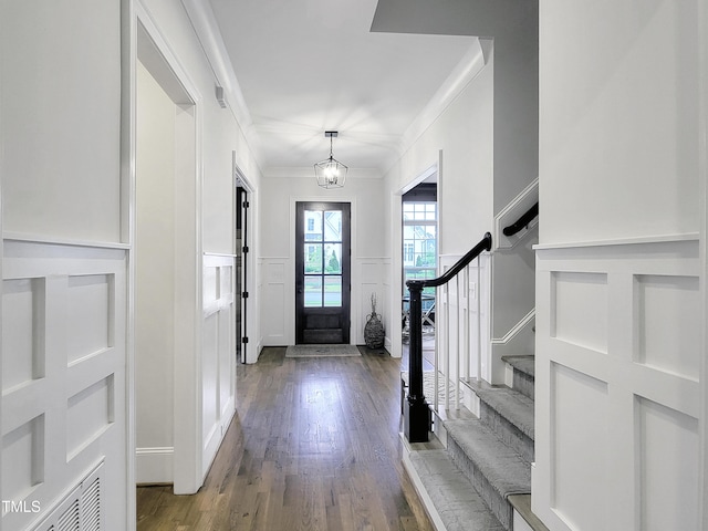 3160 Mantle Ridge Dr, Apex, NC 27502 - foyer entrance with a decorative wall, crown molding, wood finished floors, a wainscoted wall, and stairway