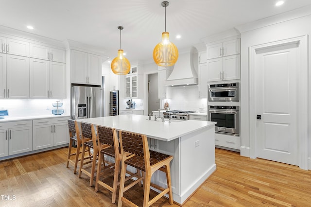 3160 Mantle Ridge Dr, Apex, NC 27502 - kitchen featuring premium range hood, tasteful backsplash, recessed lighting, appliances with stainless steel finishes, and a kitchen breakfast bar