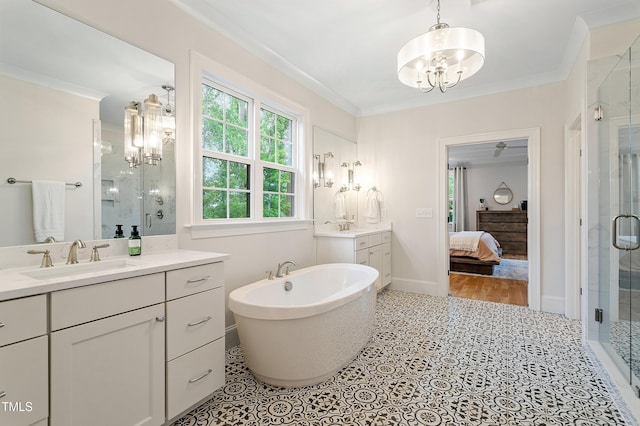 3160 Mantle Ridge Dr, Apex, NC 27502 - ensuite bathroom with a chandelier, a stall shower, vanity, ornamental molding, and a freestanding tub