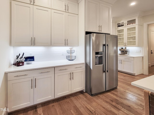3160 Mantle Ridge Dr, Apex, NC 27502 - kitchen featuring stainless steel fridge, light wood-type flooring, backsplash, and light countertops