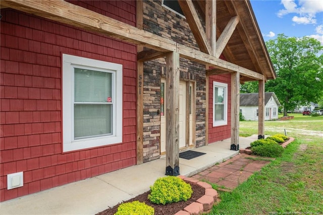 521 Cedar Creek Rd, Fayetteville, NC 28312 - view of exterior entry featuring stone siding and a porch